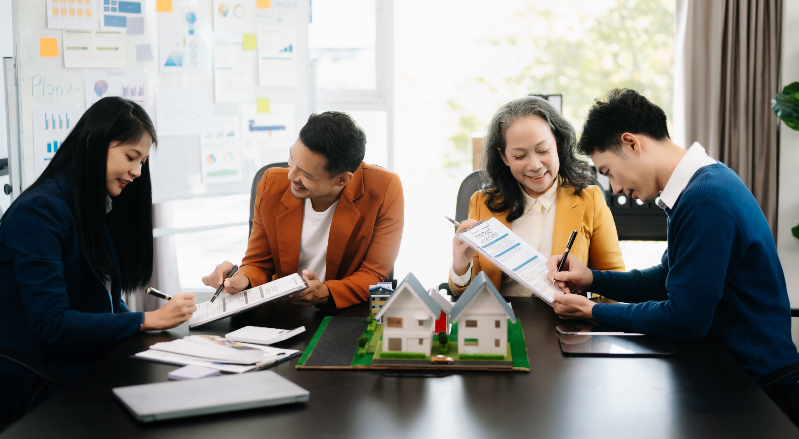 Four property managers reviewing their multi-site security plans