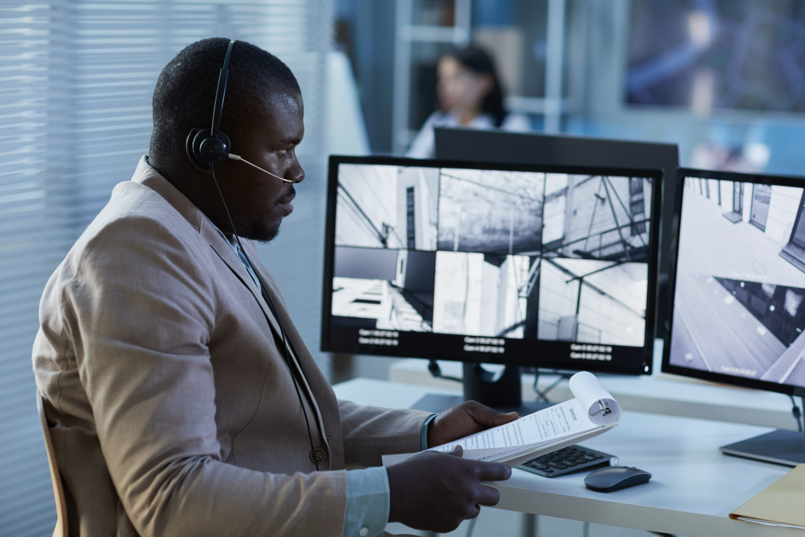 A security professional live monitoring a security station